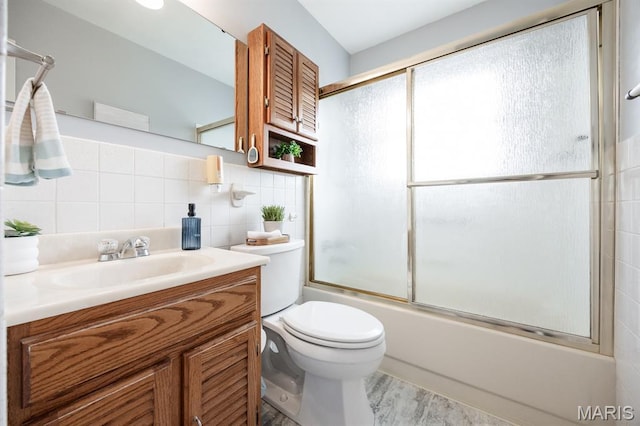 508 Joy Dr, Ofallon, IL 62269 - full bathroom featuring vanity, shower / bath combination with glass door, wood finished floors, tasteful backsplash, and tile walls