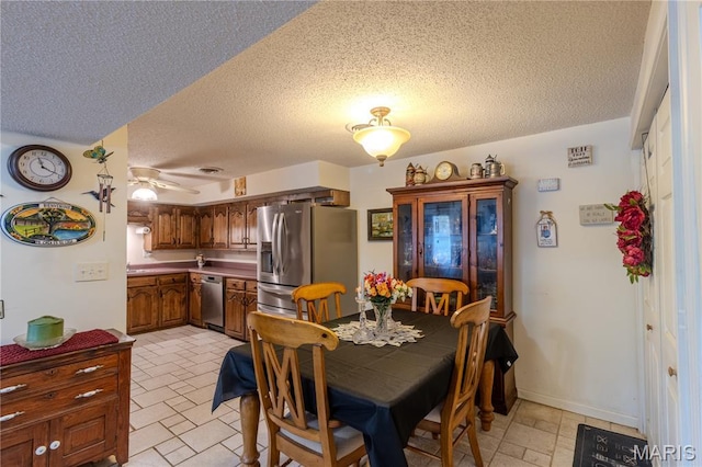 106 Red Bud Cir, Saint Robert, MO 65584 - dining area featuring a textured ceiling and ceiling fan