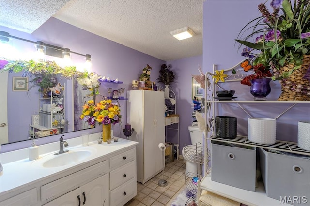 106 Red Bud Cir, Saint Robert, MO 65584 - bathroom featuring a textured ceiling, vanity, and tile patterned floors