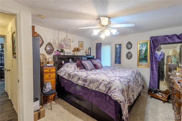 106 Red Bud Cir, Saint Robert, MO 65584 - bedroom with a textured ceiling, ceiling fan, and carpet floors
