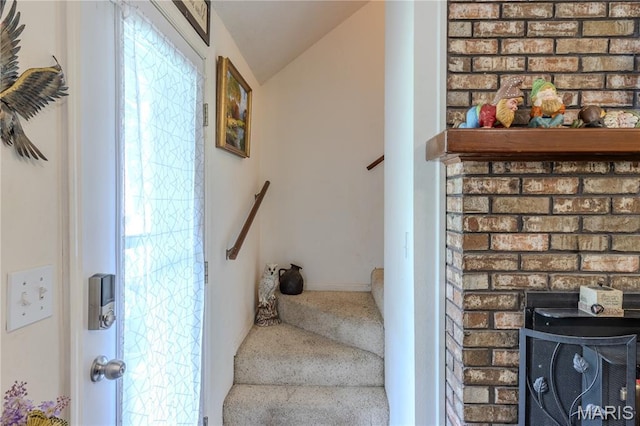 106 Red Bud Cir, Saint Robert, MO 65584 - stairs with lofted ceiling, carpet flooring, and a fireplace