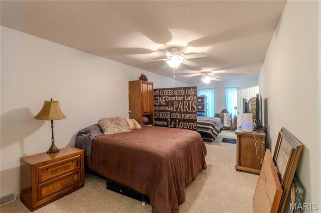 106 Red Bud Cir, Saint Robert, MO 65584 - bedroom featuring light carpet, a textured ceiling, and a ceiling fan
