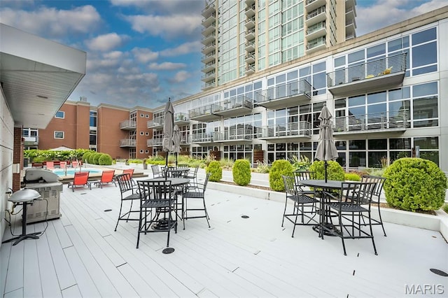 9 N Euclid Ave Unit 509, Saint Louis, MO 63108 - wooden deck with outdoor dining area and a community pool