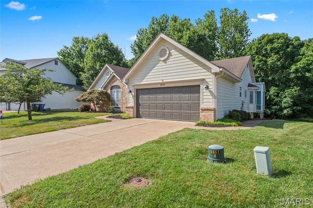 2028 During Dr, Arnold, MO 63010 - view of front of home featuring an attached garage, brick siding, concrete driveway, and a front lawn