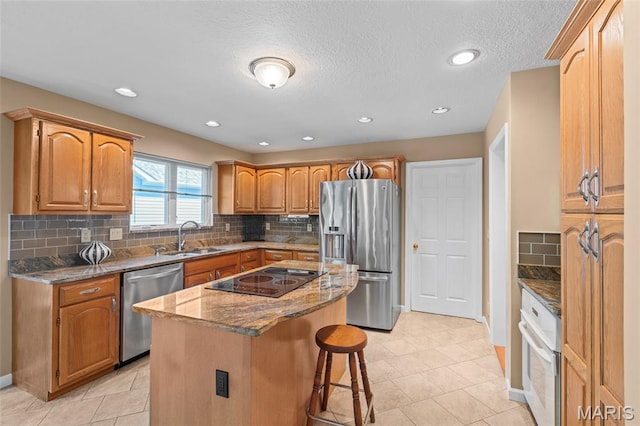 2028 During Dr, Arnold, MO 63010 - kitchen featuring appliances with stainless steel finishes, a kitchen bar, dark stone countertops, a kitchen island, and decorative backsplash
