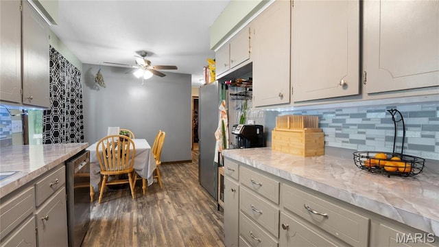 19954 Ironwood Ln, Lebanon, MO 65536 - kitchen with ceiling fan, decorative backsplash, dark wood-style floors, light countertops, and dishwasher