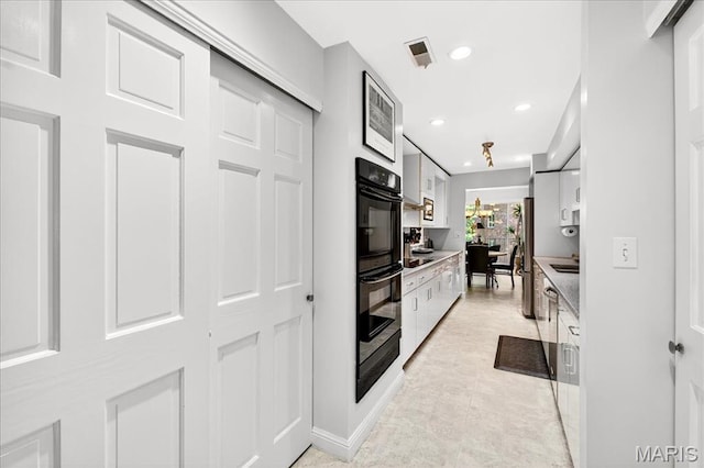 14308 Conway Meadows Ct Unit 203, Chesterfield, MO 63017 - kitchen featuring freestanding refrigerator, recessed lighting, white cabinetry, and light countertops