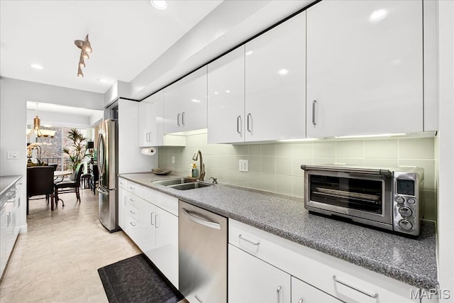 14308 Conway Meadows Ct Unit 203, Chesterfield, MO 63017 - kitchen featuring appliances with stainless steel finishes, white cabinetry, tasteful backsplash, modern cabinets, and a chandelier