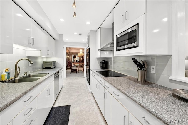 14308 Conway Meadows Ct Unit 203, Chesterfield, MO 63017 - kitchen with black appliances, wall chimney range hood, white cabinets, tasteful backsplash, and recessed lighting