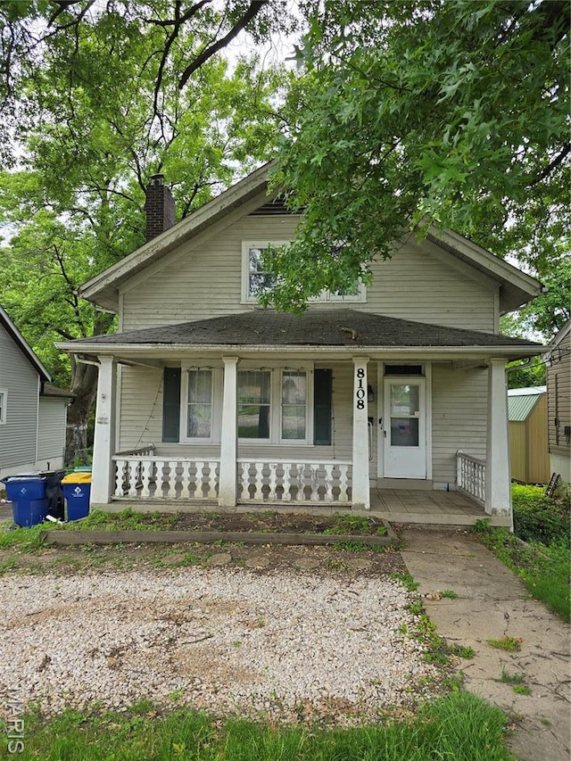 8108 Saint Charles Rock Rd, Saint Louis, MO 63114 - bungalow-style home with covered porch and a chimney