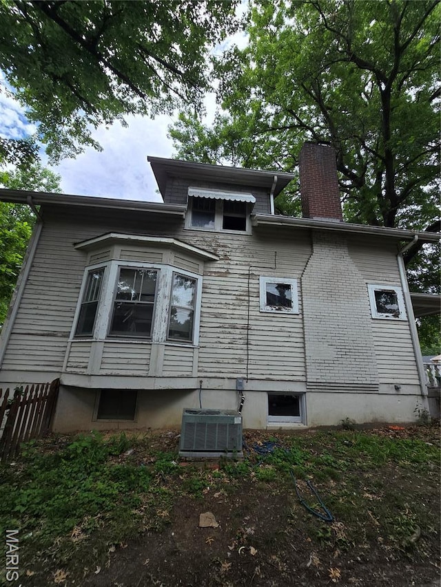 8108 Saint Charles Rock Rd, Saint Louis, MO 63114 - view of property exterior featuring a chimney and a cooling unit