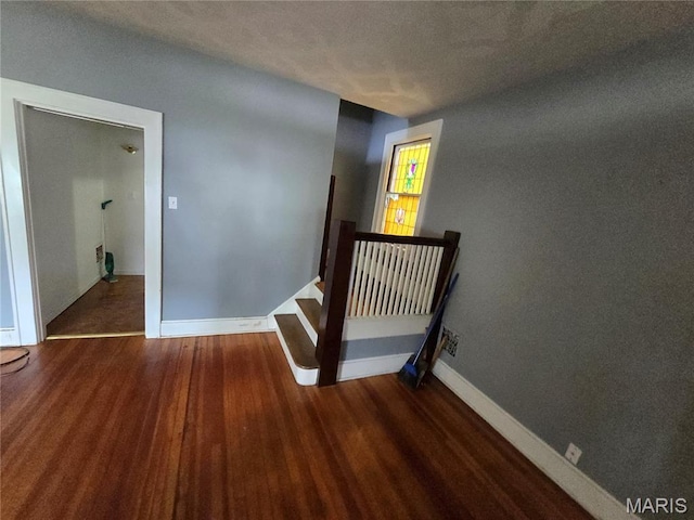 8108 Saint Charles Rock Rd, Saint Louis, MO 63114 - staircase with wood finished floors and a textured ceiling