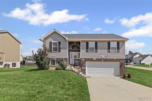 101 Shiloh Ridge Dr, Shiloh, IL 62221 - split foyer home with an attached garage, concrete driveway, a front yard, and brick siding