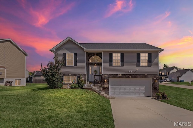 101 Shiloh Ridge Dr, Shiloh, IL 62221 - bi-level home featuring a garage, concrete driveway, a front lawn, and brick siding