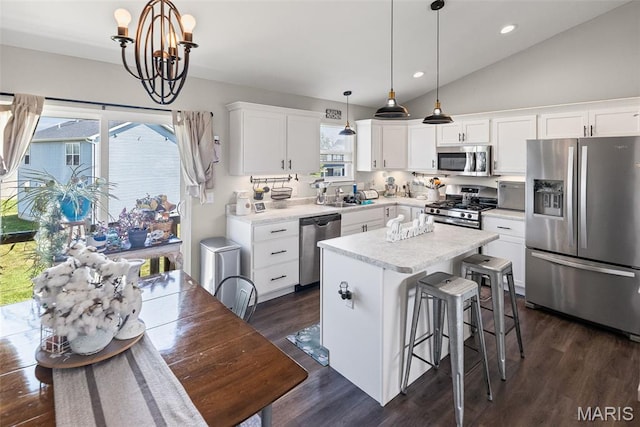 101 Shiloh Ridge Dr, Shiloh, IL 62221 - kitchen with appliances with stainless steel finishes, a chandelier, dark wood finished floors, white cabinets, and a center island