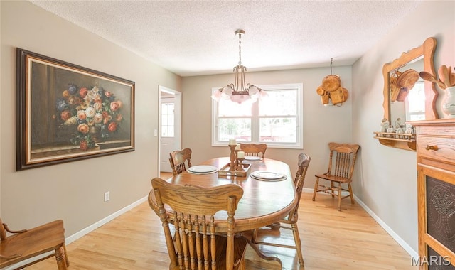 15550 US Highway 63, Rolla, MO 65401 - dining area with light wood finished floors, a textured ceiling, and a chandelier