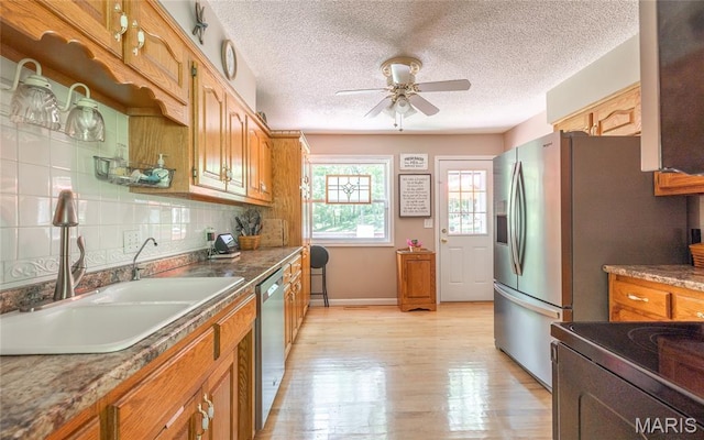 15550 US Highway 63, Rolla, MO 65401 - kitchen with dishwasher, ceiling fan, light wood-style flooring, a textured ceiling, and decorative backsplash