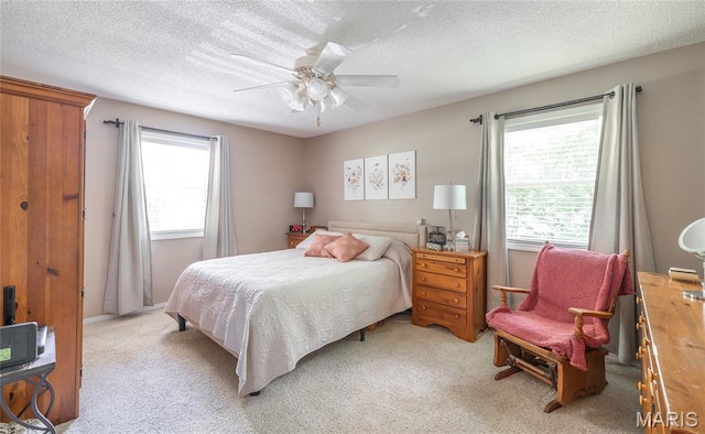15550 US Highway 63, Rolla, MO 65401 - bedroom featuring multiple windows, light colored carpet, a textured ceiling, and a ceiling fan