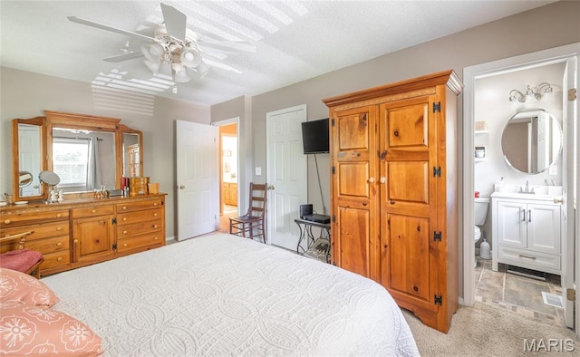 15550 US Highway 63, Rolla, MO 65401 - bedroom featuring light colored carpet, ensuite bath, a textured ceiling, a ceiling fan, and a closet