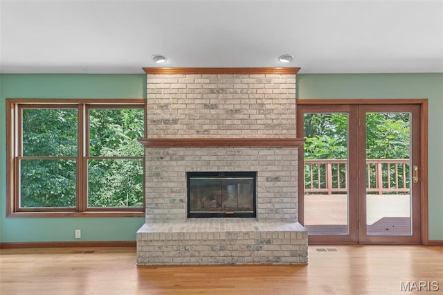 67 High Trails Dr, Eureka, MO 63025 - unfurnished living room with wood finished floors and a brick fireplace