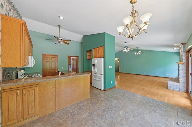 67 High Trails Dr, Eureka, MO 63025 - kitchen featuring a ceiling fan, white appliances, vaulted ceiling, open floor plan, and a peninsula
