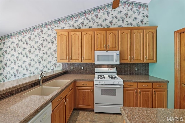 67 High Trails Dr, Eureka, MO 63025 - kitchen with white appliances, backsplash, wallpapered walls, and brown cabinets