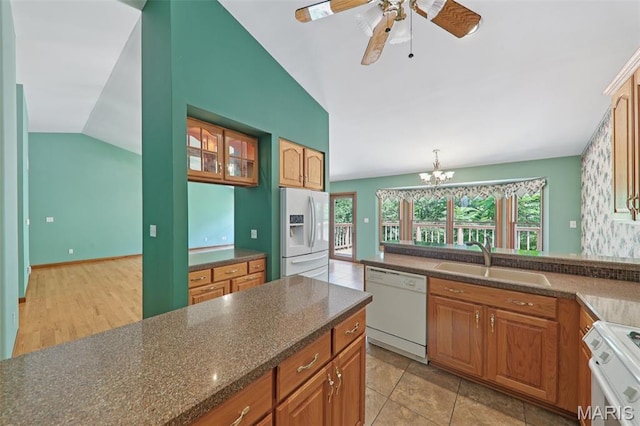 67 High Trails Dr, Eureka, MO 63025 - kitchen with white appliances, vaulted ceiling, a chandelier, a ceiling fan, and brown cabinetry