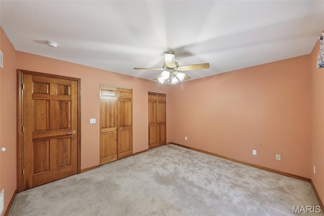 67 High Trails Dr, Eureka, MO 63025 - unfurnished bedroom with two closets, light carpet, and a ceiling fan