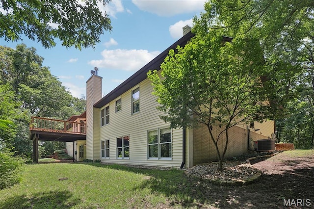 67 High Trails Dr, Eureka, MO 63025 - back of house featuring a chimney, a lawn, and a deck