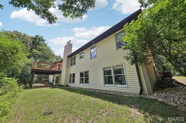 67 High Trails Dr, Eureka, MO 63025 - back of property with a chimney, a wooden deck, and a yard