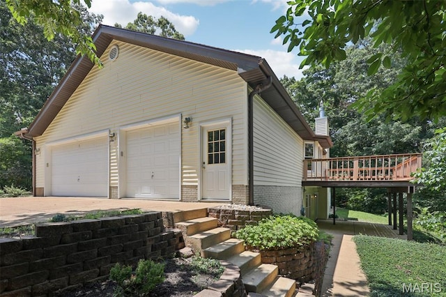67 High Trails Dr, Eureka, MO 63025 - view of side of home featuring a wooden deck, brick siding, and driveway