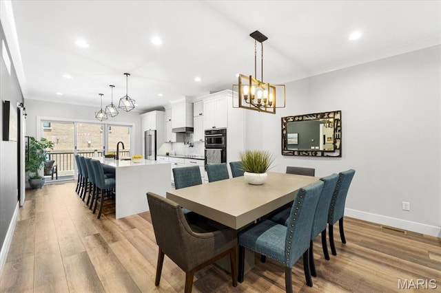 9 E Main St, Washington, MO 63090 - dining area with a chandelier, light wood-type flooring, ornamental molding, and recessed lighting