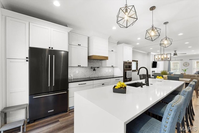 9 E Main St, Washington, MO 63090 - kitchen featuring high end refrigerator, recessed lighting, custom range hood, dark wood-type flooring, and decorative backsplash