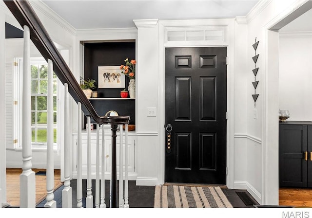 1855 Grassy Ridge Rd, Kirkwood, MO 63122 - entrance foyer featuring stairs, healthy amount of natural light, ornamental molding, a decorative wall, and a wainscoted wall