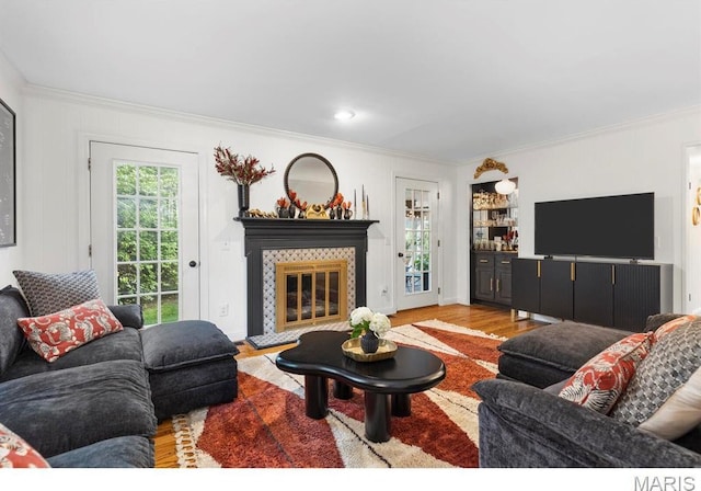 1855 Grassy Ridge Rd, Kirkwood, MO 63122 - living room featuring crown molding, wood finished floors, and a tiled fireplace