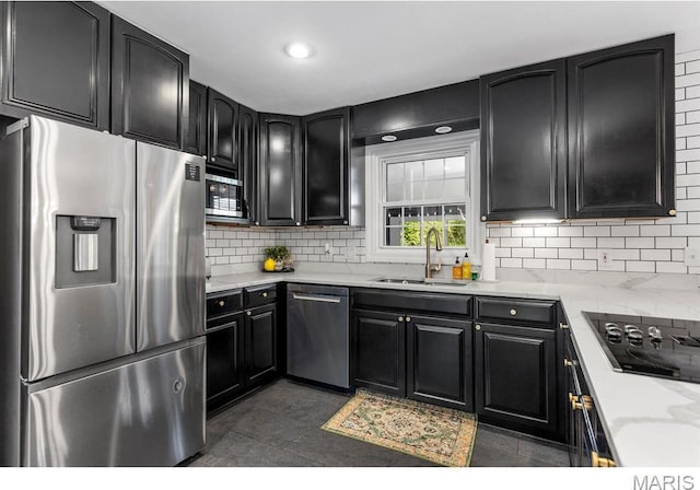 1855 Grassy Ridge Rd, Kirkwood, MO 63122 - kitchen featuring appliances with stainless steel finishes, dark cabinets, backsplash, light stone counters, and recessed lighting