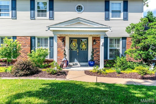 2211 Viewroyal Dr, Des Peres, MO 63131 - doorway to property featuring brick siding and a yard