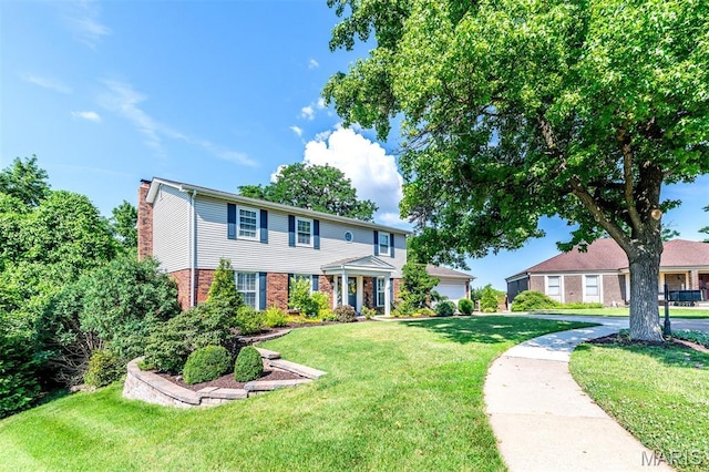 2211 Viewroyal Dr, Des Peres, MO 63131 - view of front facade featuring brick siding, a front yard, and a chimney