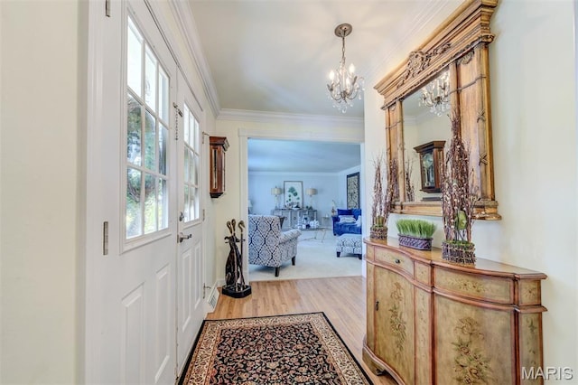 2211 Viewroyal Dr, Des Peres, MO 63131 - foyer entrance featuring a chandelier, ornamental molding, and wood finished floors