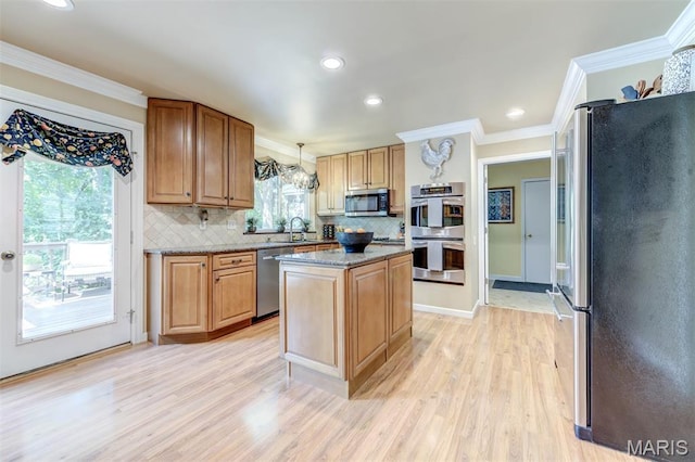 2211 Viewroyal Dr, Des Peres, MO 63131 - kitchen with appliances with stainless steel finishes, light wood finished floors, decorative backsplash, ornamental molding, and a kitchen island