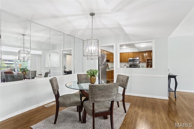 520 S Brentwood Blvd Unit 3A, Saint Louis, MO 63105 - dining space featuring a chandelier and wood finished floors