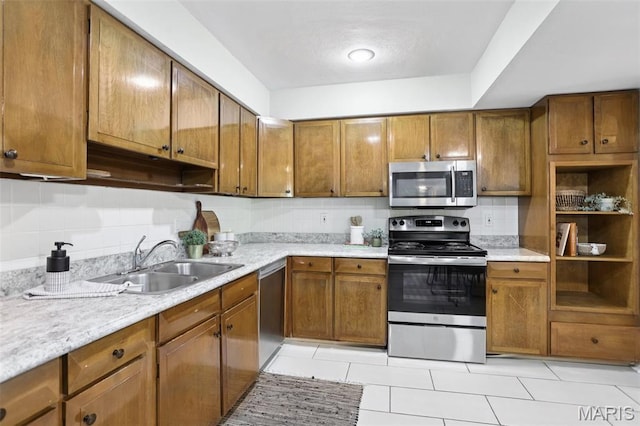 520 S Brentwood Blvd Unit 3A, Saint Louis, MO 63105 - kitchen featuring appliances with stainless steel finishes, brown cabinets, light countertops, and light tile patterned floors