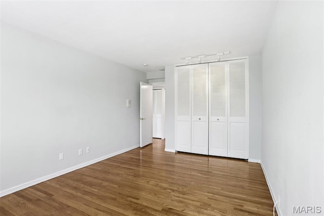 520 S Brentwood Blvd Unit 3A, Saint Louis, MO 63105 - unfurnished bedroom featuring wood finished floors and a closet