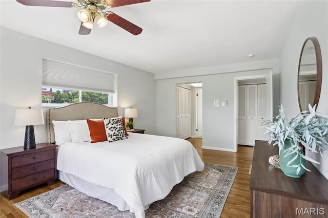 520 S Brentwood Blvd Unit 3A, Saint Louis, MO 63105 - bedroom featuring wood finished floors, two closets, and ceiling fan