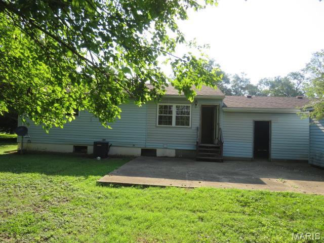 5129 Rapp Rd, Granite City, IL 62040 - back of house with a patio area, entry steps, and a lawn