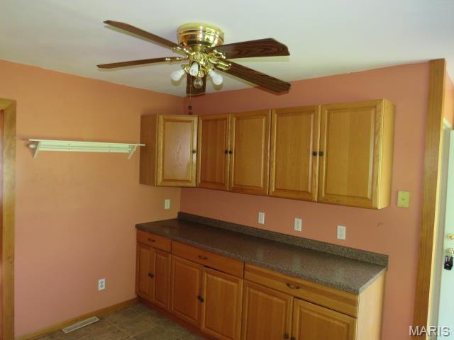 5129 Rapp Rd, Granite City, IL 62040 - kitchen with a ceiling fan and dark countertops