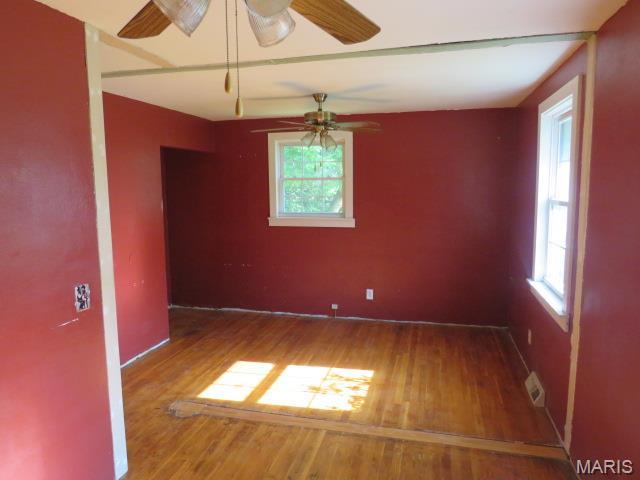 5129 Rapp Rd, Granite City, IL 62040 - empty room featuring plenty of natural light, wood finished floors, and a ceiling fan