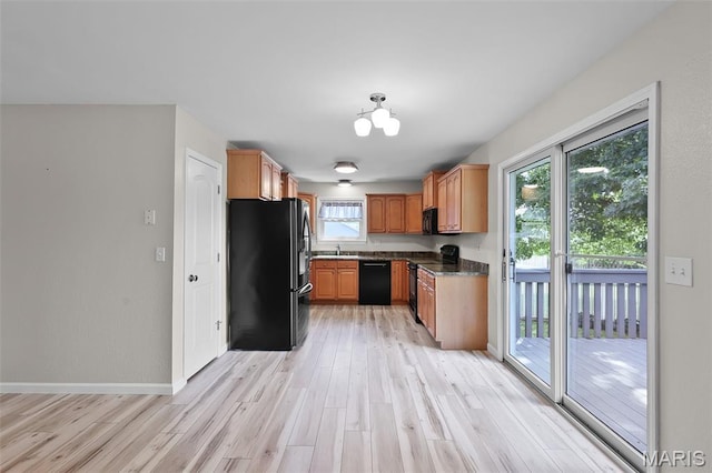 1016 Andra Dr, Maryville, IL 62062 - kitchen with black appliances, light wood-type flooring, dark countertops, and a chandelier