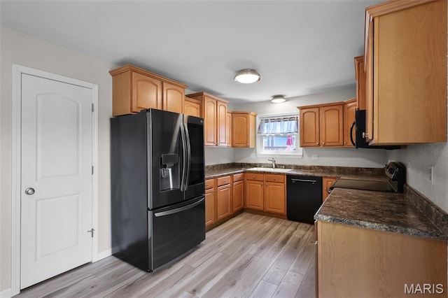 1016 Andra Dr, Maryville, IL 62062 - kitchen featuring black appliances, light wood finished floors, and dark countertops