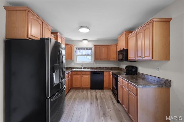 1016 Andra Dr, Maryville, IL 62062 - kitchen featuring black appliances, dark countertops, and light wood-style floors